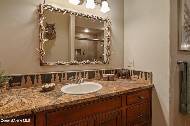 bathroom with a stall shower and vanity