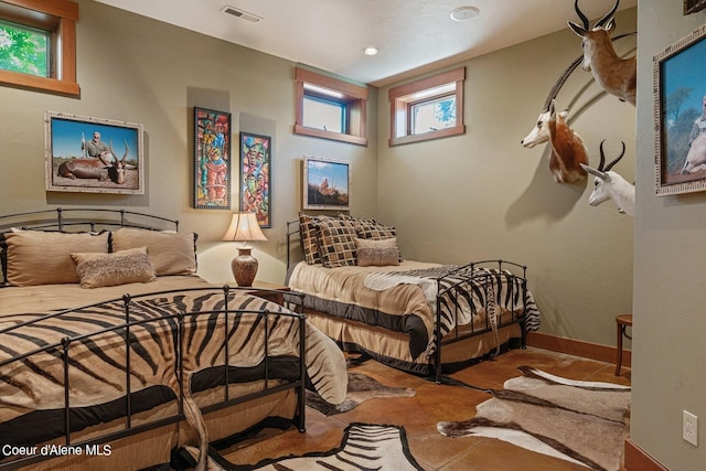 bedroom with baseboards, visible vents, and recessed lighting
