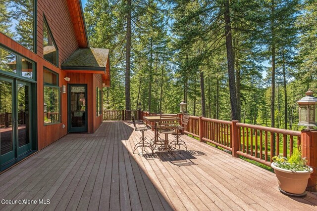 wooden deck featuring french doors and outdoor dining area