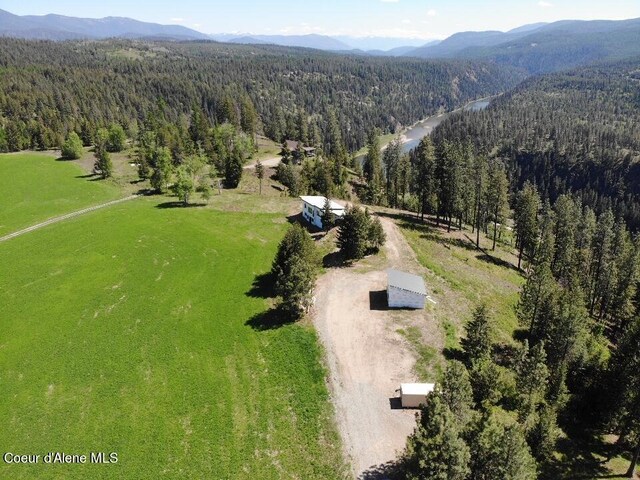 birds eye view of property featuring a mountain view and a rural view