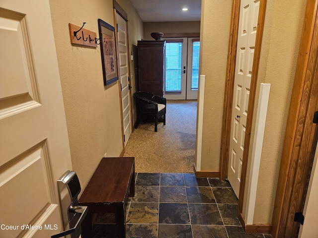 corridor featuring dark tile floors