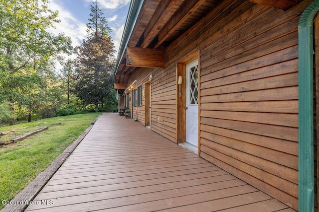 wooden terrace with a yard