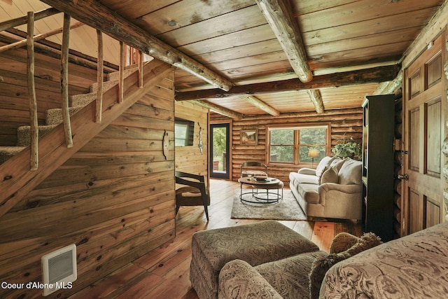 living room featuring wooden ceiling, hardwood / wood-style floors, rustic walls, and beamed ceiling