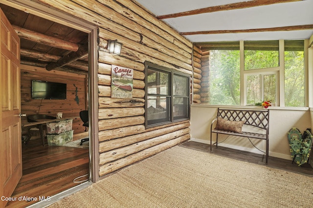 sunroom featuring beamed ceiling