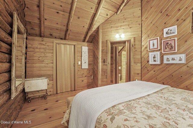 bedroom featuring wooden walls, lofted ceiling with beams, and wood ceiling