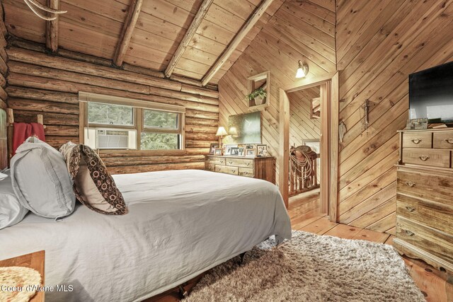 bedroom featuring cooling unit, light hardwood / wood-style floors, rustic walls, wooden ceiling, and beam ceiling