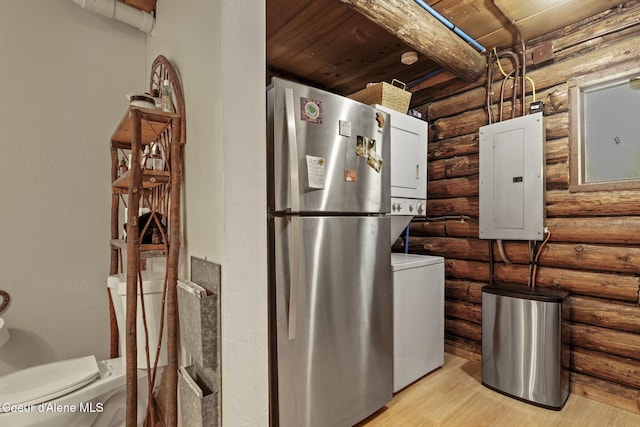 interior space with electric panel and stacked washer / dryer