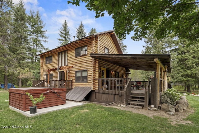 rear view of property featuring a lawn and a deck