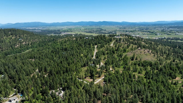 17536 W Julia Dr, Hauser, ID 83854 - aerial view of property and surrounding area featuring a mountain backdrop and a heavily wooded area