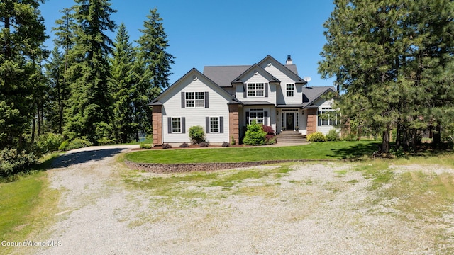 17536 W Julia Dr, Hauser, ID 83854 - view of front of home featuring a chimney, a front yard, and dirt driveway