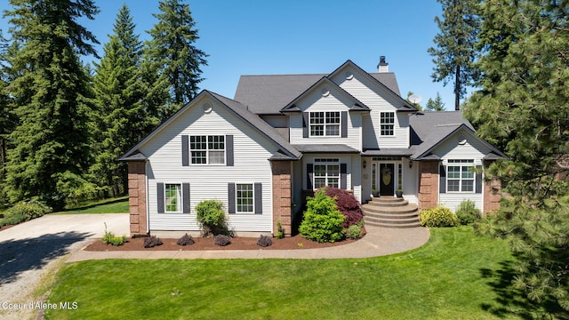 17536 W Julia Dr, Hauser, ID 83854 - view of front facade with a chimney, a front yard, and brick siding
