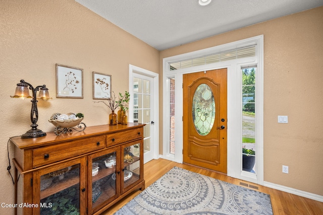 17536 W Julia Dr, Hauser, ID 83854 - foyer with baseboards and light wood-style floors