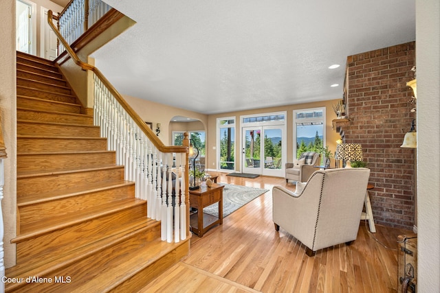 17536 W Julia Dr, Hauser, ID 83854 - living room with wood finished floors, stairway, recessed lighting, and arched walkways