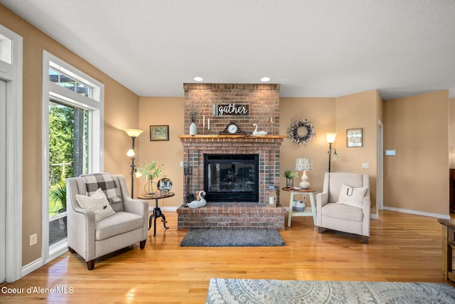 17536 W Julia Dr, Hauser, ID 83854 - living room featuring wood finished floors, a fireplace, and recessed lighting