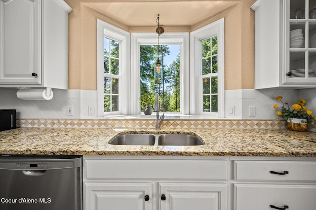 17536 W Julia Dr, Hauser, ID 83854 - kitchen with stainless steel dishwasher, glass insert cabinets, white cabinets, and backsplash