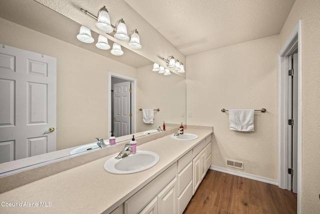 17536 W Julia Dr, Hauser, ID 83854 - full bathroom with double vanity and wood finished floors