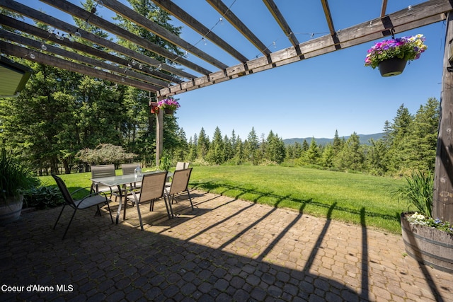 17536 W Julia Dr, Hauser, ID 83854 - view of patio / terrace featuring outdoor dining area, a pergola, and a mountain view