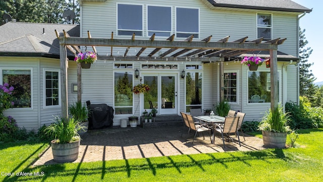 17536 W Julia Dr, Hauser, ID 83854 - back of house featuring a pergola, a patio area, a yard, and a shingled roof