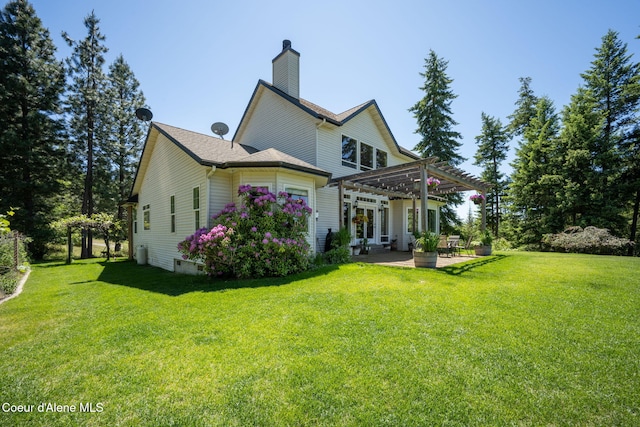 17536 W Julia Dr, Hauser, ID 83854 - back of house featuring a pergola, a patio area, a yard, and a chimney
