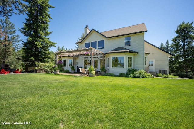 17536 W Julia Dr, Hauser, ID 83854 - rear view of house with a pergola, a chimney, a yard, and a patio area