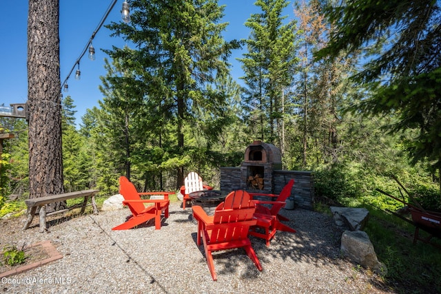 17536 W Julia Dr, Hauser, ID 83854 - view of patio / terrace featuring an outdoor stone fireplace