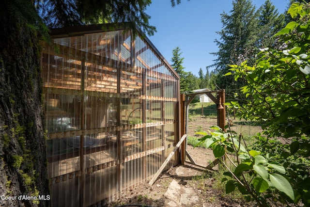 17536 W Julia Dr, Hauser, ID 83854 - view of home's exterior with a greenhouse and an outbuilding