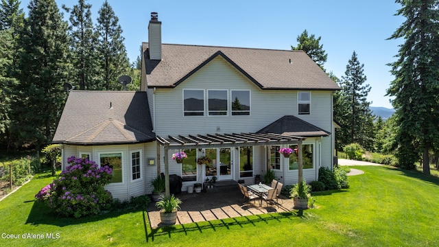 17536 W Julia Dr, Hauser, ID 83854 - rear view of property featuring a pergola, a chimney, a lawn, and a patio area
