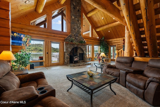 carpeted living area featuring log walls, a wealth of natural light, wooden ceiling, and beam ceiling