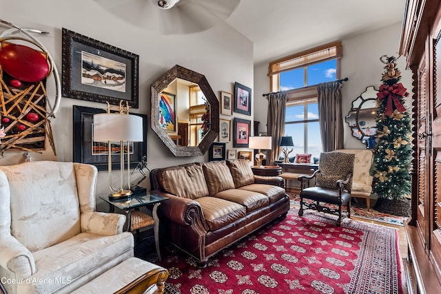 living room featuring wood-type flooring and ceiling fan