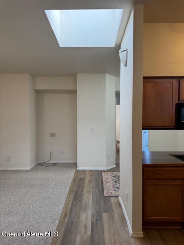 interior space featuring light hardwood / wood-style floors and a skylight