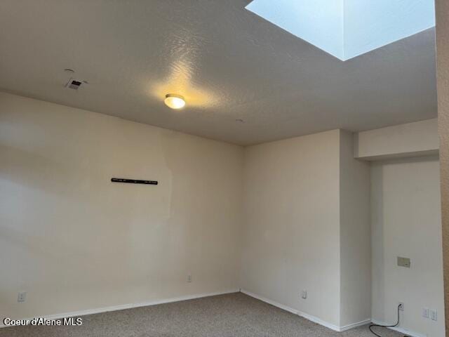 empty room with a textured ceiling and carpet floors