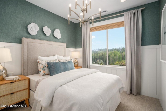 bedroom featuring carpet floors and a chandelier