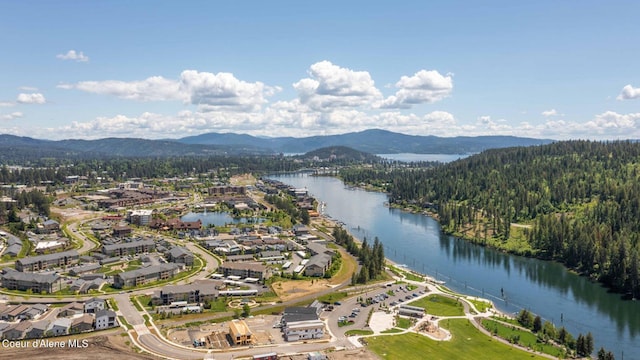 drone / aerial view featuring a water and mountain view