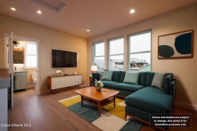 living room with recessed lighting, light wood-type flooring, and baseboards