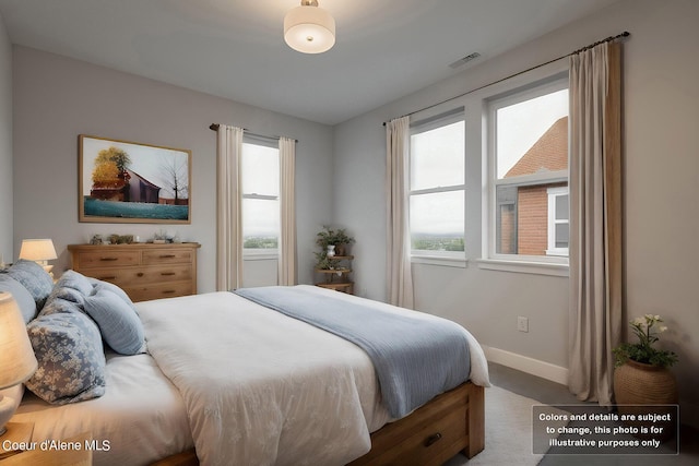 bedroom with visible vents, multiple windows, baseboards, and carpet floors