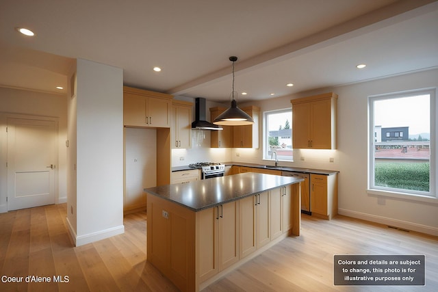 kitchen featuring light wood-type flooring, a sink, stainless steel appliances, wall chimney exhaust hood, and baseboards