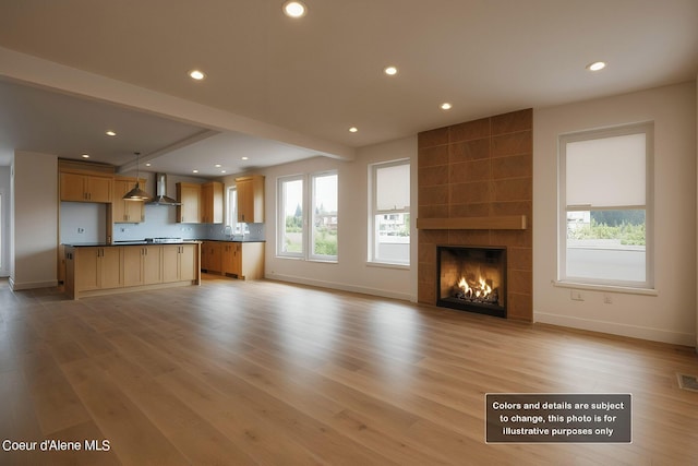 unfurnished living room featuring recessed lighting, light wood-type flooring, and plenty of natural light