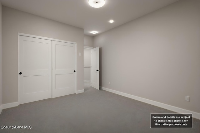 unfurnished bedroom with carpet, a closet, and baseboards