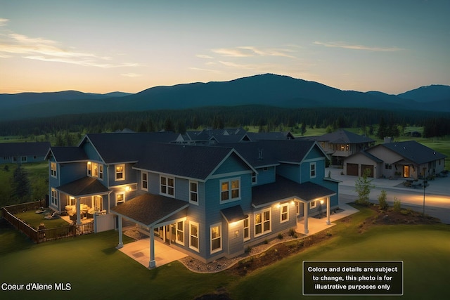 exterior space with fence, a mountain view, and dirt driveway