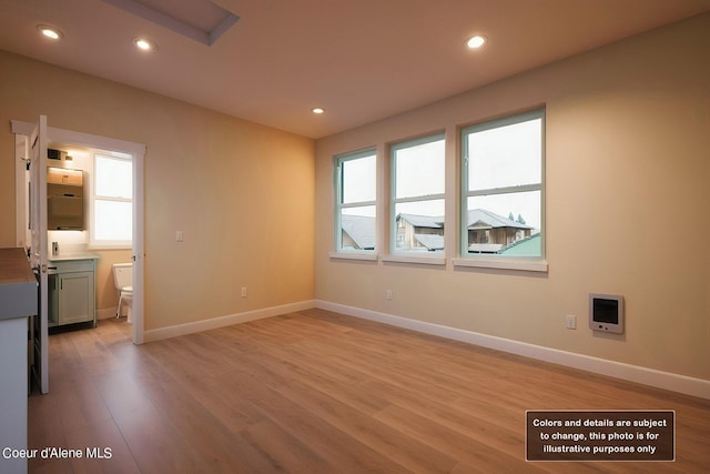 interior space with a wealth of natural light, light wood-style flooring, and recessed lighting