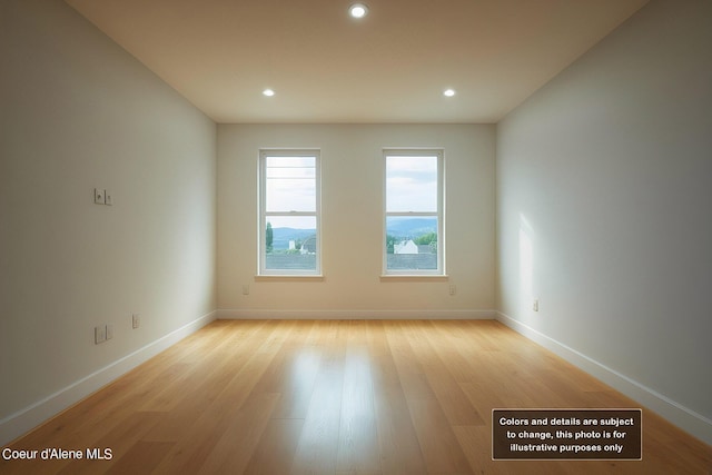 unfurnished room with recessed lighting, light wood-style flooring, and baseboards