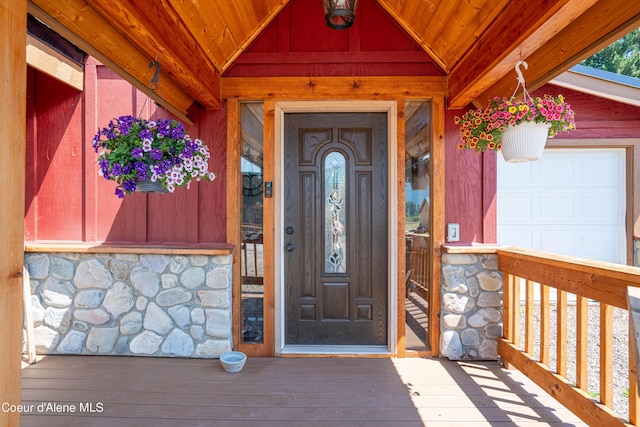 property entrance with a porch and stone siding