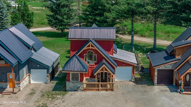 exterior space with fence, dirt driveway, board and batten siding, and stone siding