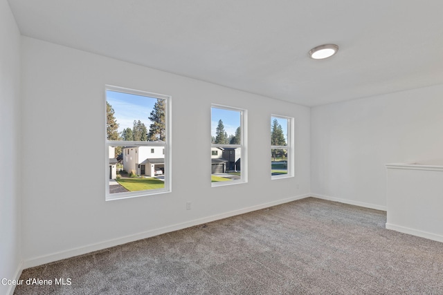 unfurnished room with carpet floors and plenty of natural light