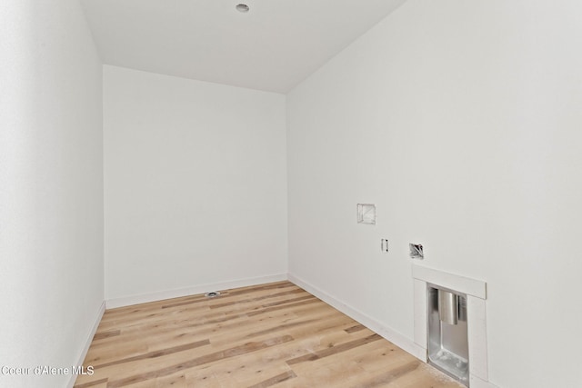 laundry area featuring hookup for an electric dryer, light hardwood / wood-style flooring, and washer hookup