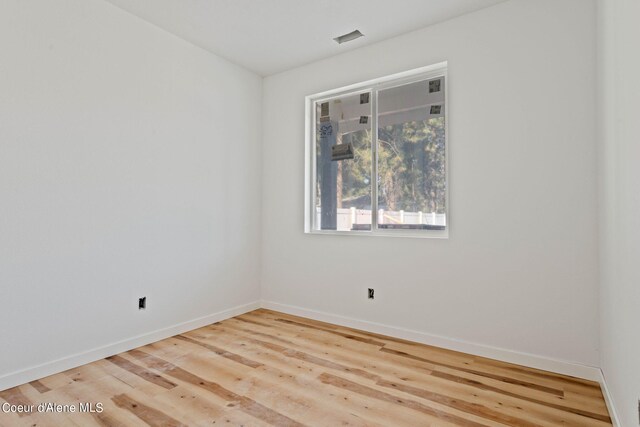 spare room featuring light hardwood / wood-style flooring