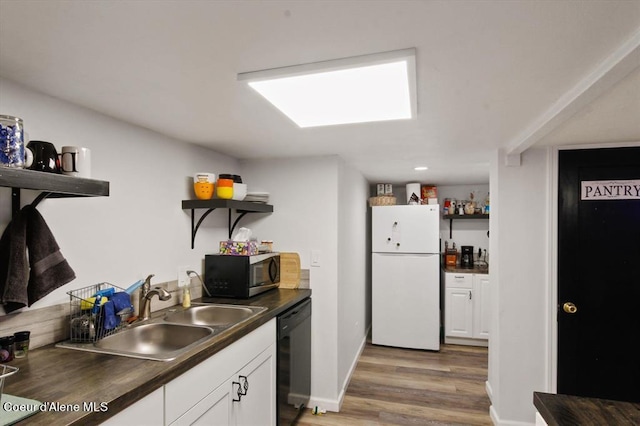 kitchen with dishwasher, sink, white cabinets, white refrigerator, and light hardwood / wood-style floors