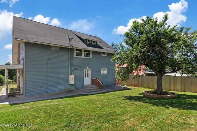 back of property featuring a yard