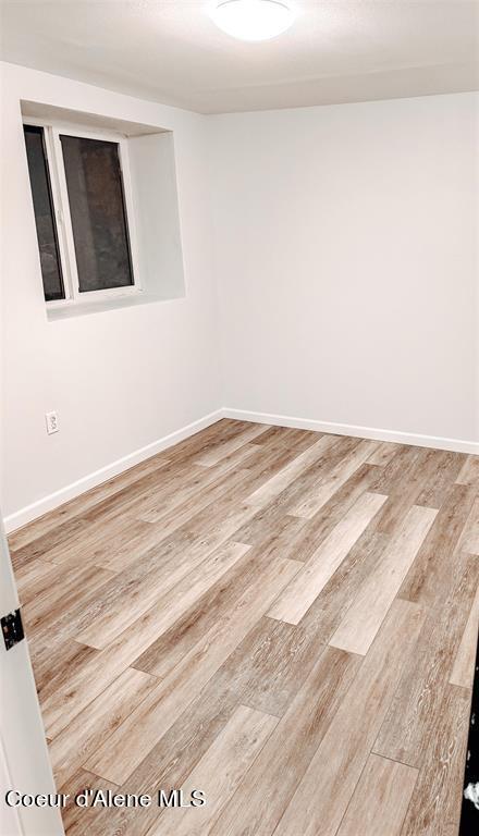 unfurnished room featuring wood-type flooring
