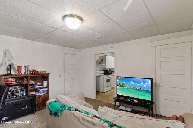 carpeted living room featuring a paneled ceiling